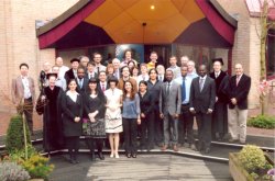 A group of people standing in front of a building

Description automatically generated